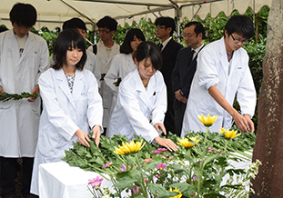 献花を行う教職員及び学生